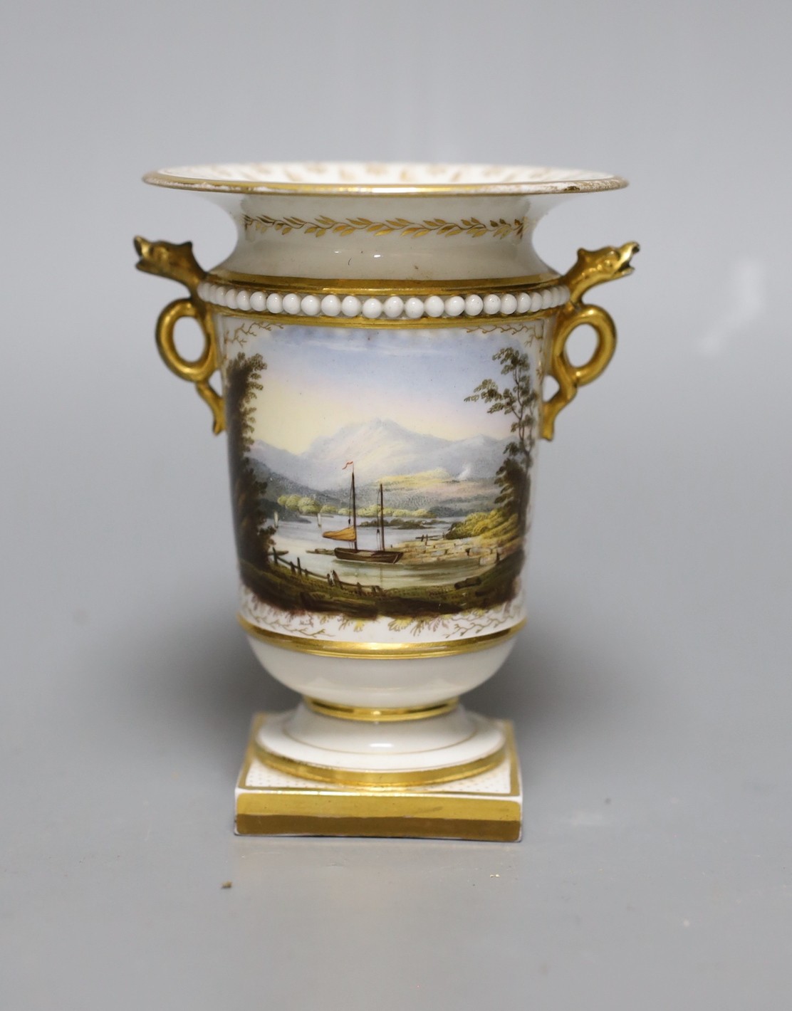 An early 19th c. Flight Barr and Barr Worcester fine spill vase with serpent head handles painted with a landscape of a small sailing boat at dock, titled Windermere, Westmorland script mark, 11 cms high
